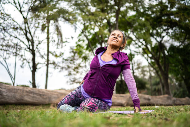 istock Senior woman stretching in a park 1415828533