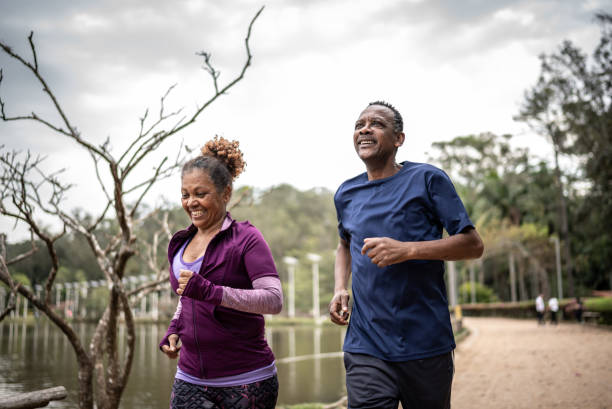 istock Senior couple jogging in a park 1415828550