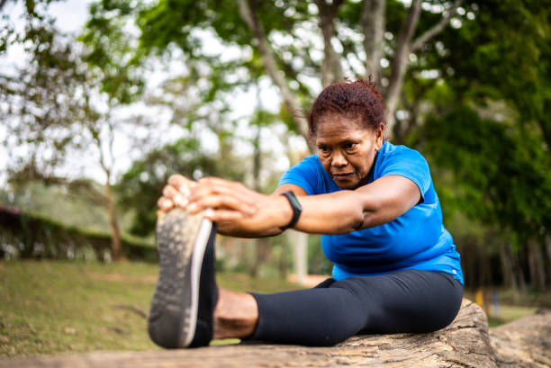 istock Senior woman stretching in a park 1415828551