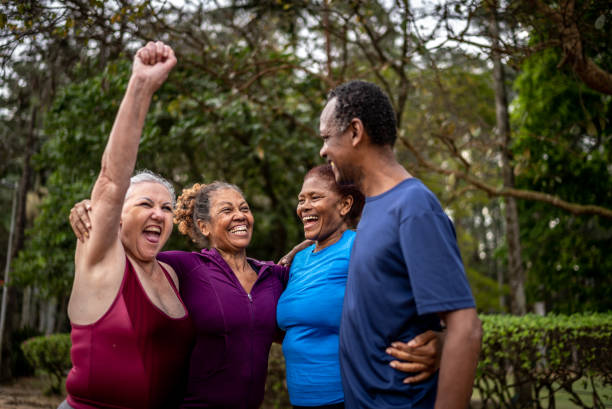 istock Happy senior friends embracing in a park 1415828703