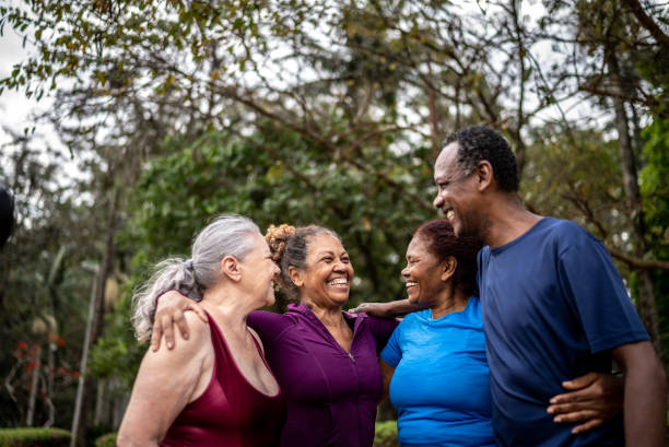 istock Happy senior friends embracing in a park 1415828712