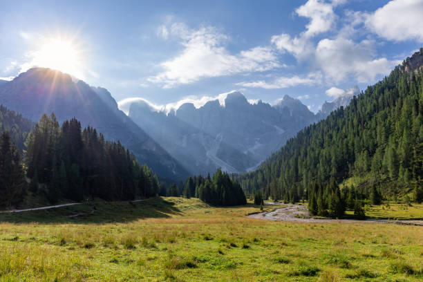 istock Mountain valley with the sun behind the peaks 1415828727