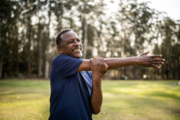 istock Senior man stretching in a park 1415829614