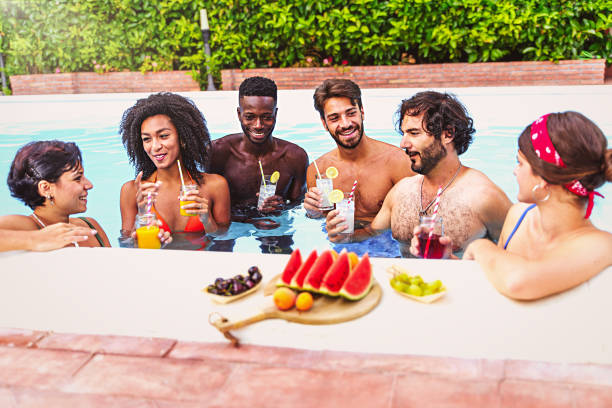 Millennial generation people at swimming pool party stock photo