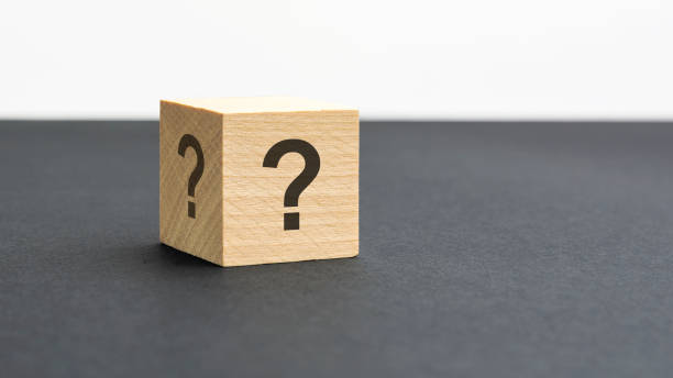 istock wooden block with question marks on black background, business teamwork concept 1415831247
