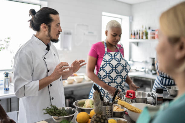 istock Chef giving instructions to adult students 1415832030