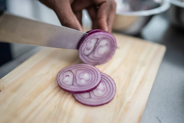 istock Female hands chopping onions 1415832039