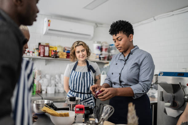 istock Chef giving instructions to adult students 1415832050