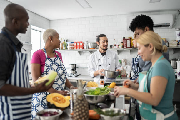 istock Chef giving instructions to adult students in a cooking class 1415832093