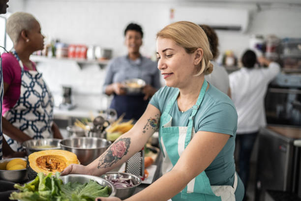 istock Woman holding bowl during cooking class 1415832151