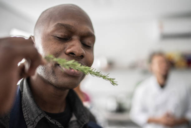 istock Man smelling fresh herbs in a cooking class 1415832259