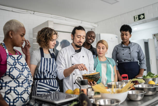 istock Chef giving instructions to students at cooking class 1415832518