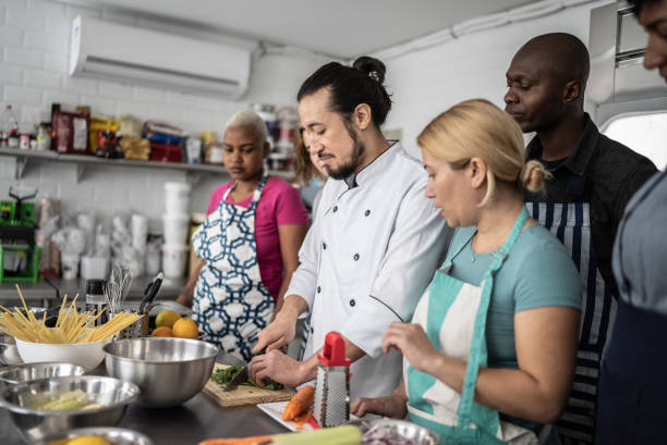 istock Chef giving instructions to students at cooking class 1415832524