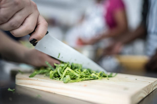 Female hands chopping green cabbage