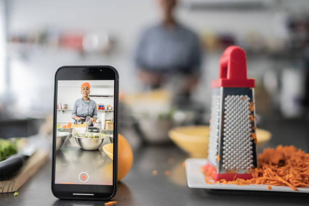 Chef filming cooking class on smartphone