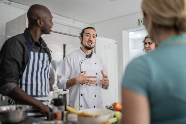 istock Chef giving instructions to students in a cooking class 1415832702