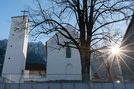 Schaan, Liechtenstein, February 13, 2022 Sun rays behind the holy Saint Peter chapel in the morning time