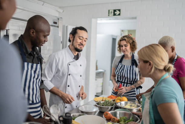 istock Chef giving instructions to students in a cooking class 1415832768