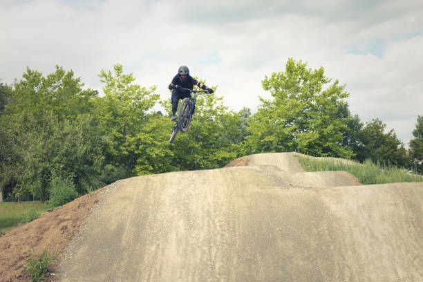 jumping table top jumps on a dirtpark track with the mountain bike.