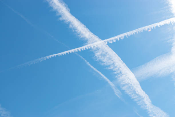 istock Contrails in the blue sky over Switzerland 1415833024