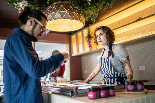 istock Employee talking to customer in an ice cream store 1415833272
