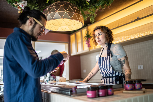 Employee talking to customer in an ice cream store