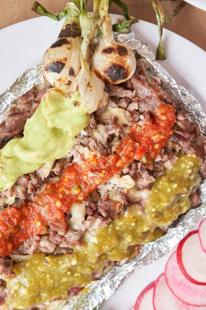 istock variety of delicious typical mexican food, tacos, sopes, pastor. 1415836635