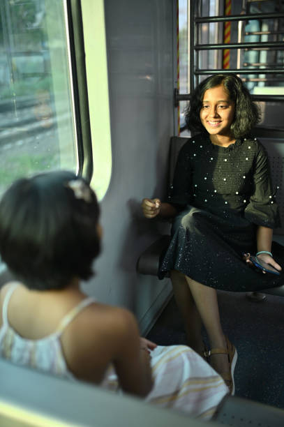 istock Two girls enjoying a train ride 1415837609