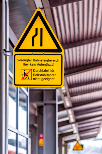 istock warning sign for a narrowed station platform in germany 1415847537