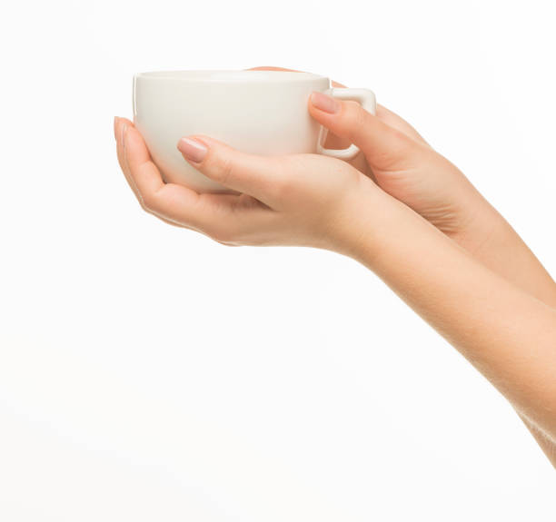 istock female hands hold a white cup on a white background isolated 1415850717