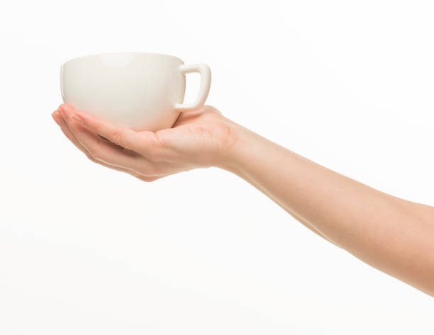istock female hands hold a white cup on a white background isolated 1415850720