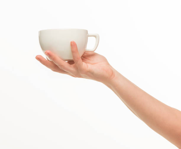 istock female hands hold a white cup on a white background isolated 1415850722