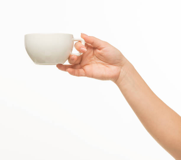 istock female hands hold a white cup on a white background isolated 1415850723