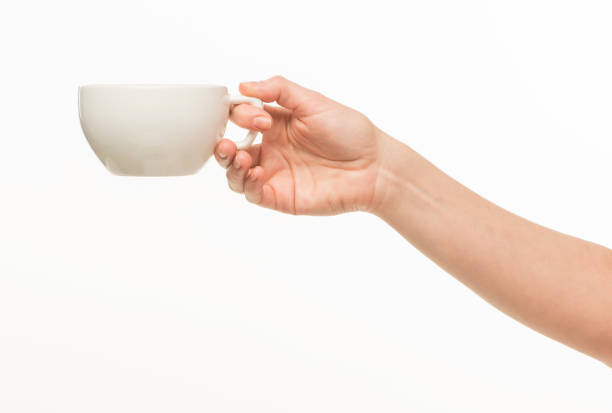 istock female hands hold a white cup on a white background isolated 1415850726