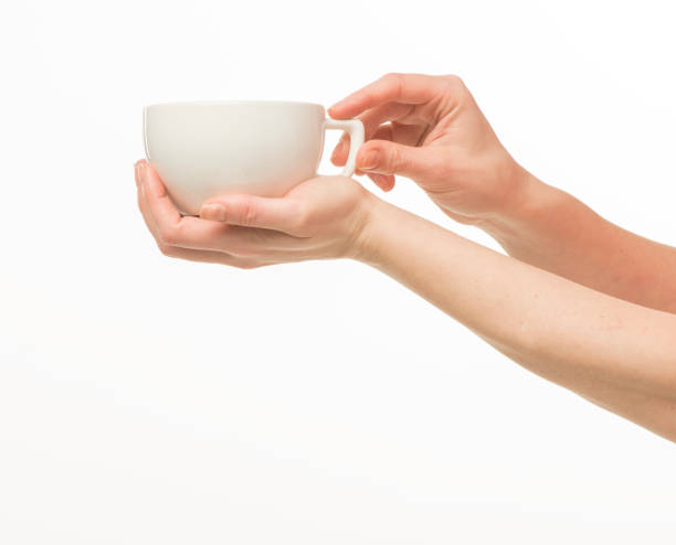 istock female hands hold a white cup on a white background isolated 1415850727