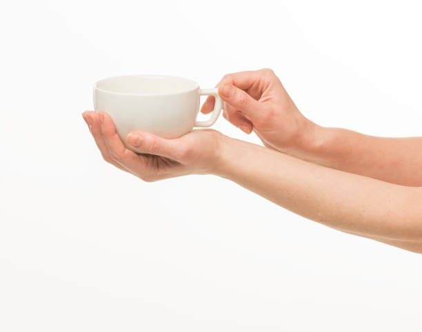 istock female hands hold a white cup on a white background isolated 1415850728