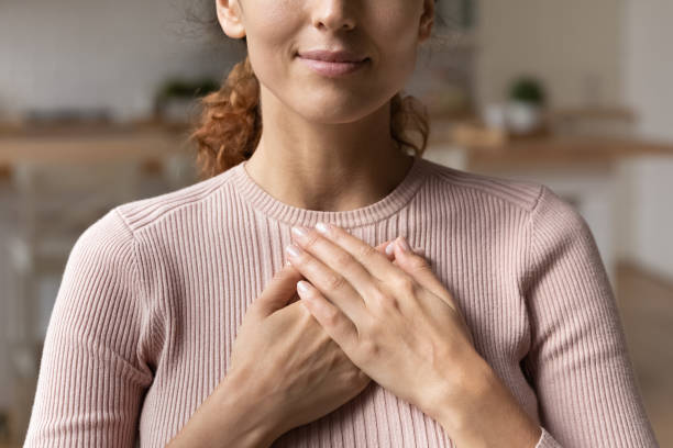 istock Sincere woman put folded palms on chest feeling gratitude closeup 1415850798