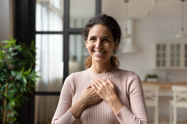 istock Hispanic woman put folded palms on chest feels gratitude 1415850809