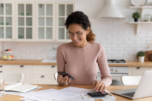 istock Woman makes calculations, pay bills through e-bank app on smartphone 1415850959