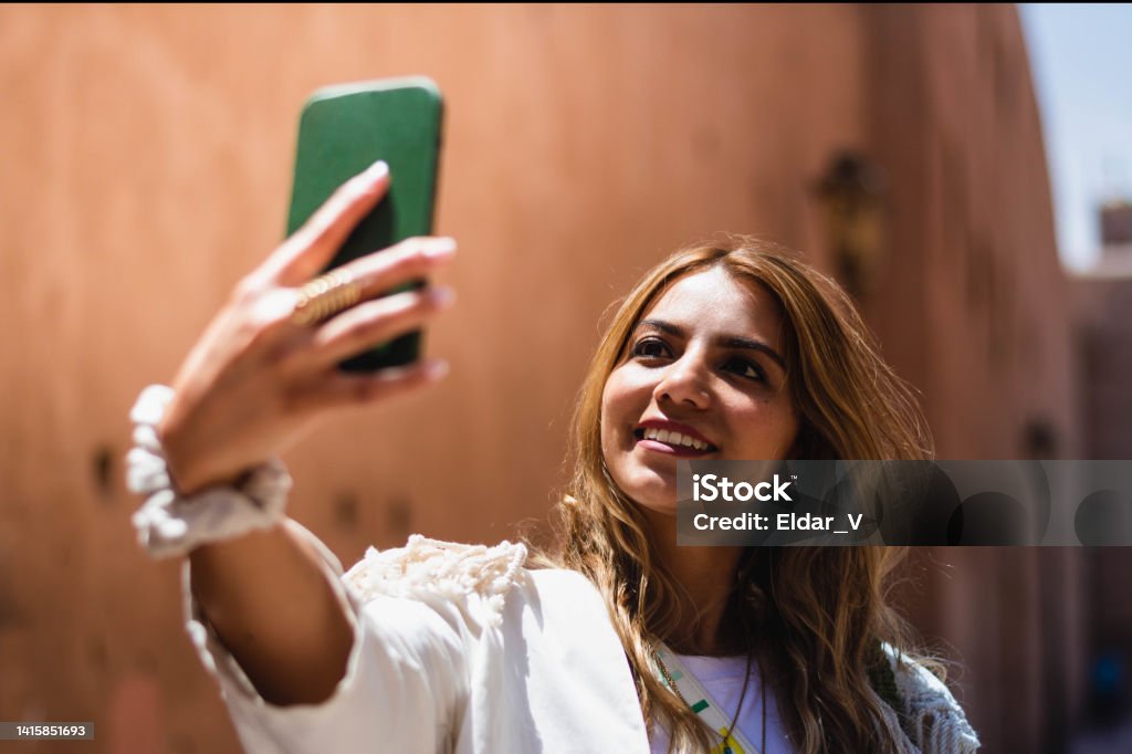 selfie of latin woman in morocco selfie of latin woman in morocco on the streets of marrakech one summer day. One Woman Only Stock Photo