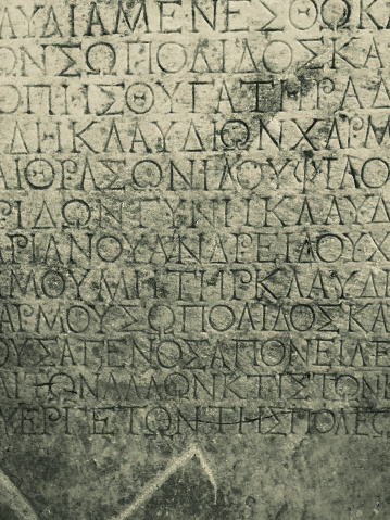 ancient Greek text curved on broken stone tablet