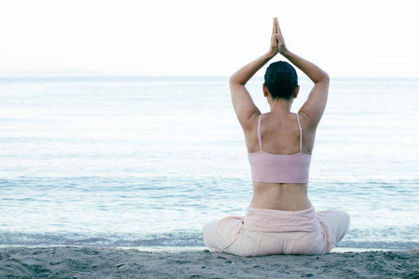 istock Yoga At The Beach 1415852547