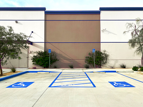 a parking lot commercial disable car park space disabled handicap designated sign posted building entrance