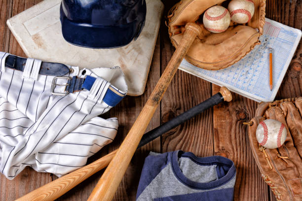 istock Overhead view of baseball gear on a rustic wood surface 1415853996