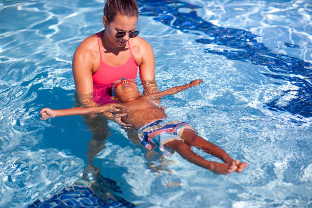 Swimming Instructor Teaching 3 year old how to Swim