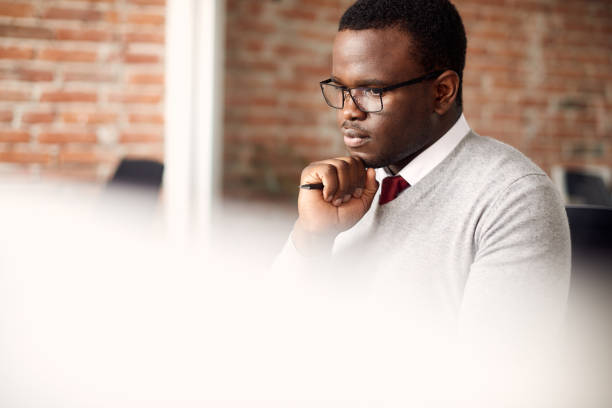 istock Distraught black businessman working on a computer in the office. 1415855252