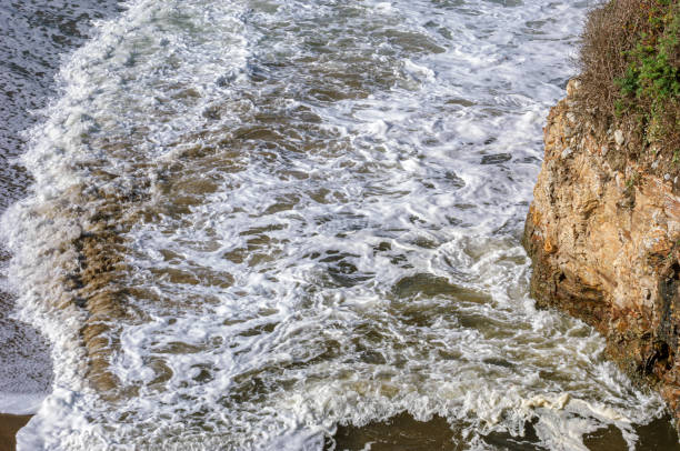istock Ocean Waves Crashing on Coastal Rocks 1415856256