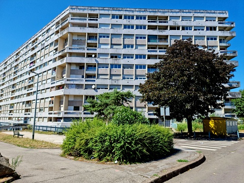Planoise is an urban area in the western part of Besançon, France, built in the 1960s. The City district mostly in block shape built has arround 17'000 citizens. The image shows a tall residential building captured during summer season.