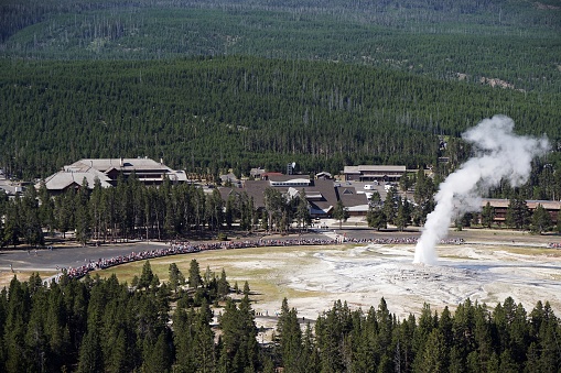 Crowds gather to watch the Old Faithful geyser erupt in Yellowstone National Park
