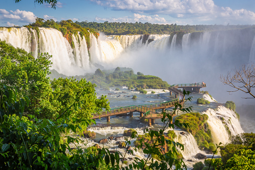 People walking along the footbridges of the Iguazu River in Argentina. Concept of tourism.